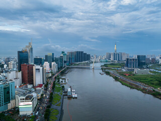 Fototapeta premium Aerial drone skyline video of Saigon cityscape at sunset in District 1, with Sai Gon river view