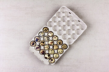 an open paper tray with quail eggs on a gray background with a copy space, top view - 789979007