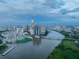 Fototapeta premium Aerial drone skyline video of Saigon cityscape at sunset in District 1, with Sai Gon river view