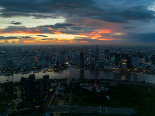 Aerial drone skyline video of Saigon cityscape at sunset in District 1, with Sai Gon river view