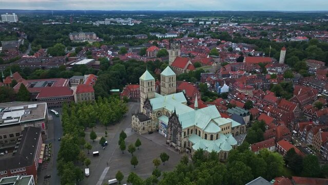 An aerial drone shot of St. Paulus Dom, also known as M&uuml;nster Cathedral, on Domplatz in M&uuml;nster on a sunny day. It is a central and culturally significant area of central M&uuml;nster, Germany. 
