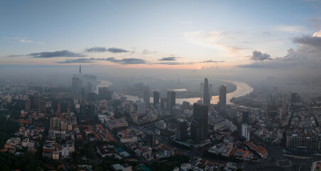 Fototapeta na wymiar Aerial drone skyline video of Saigon cityscape at sunrise in District 1, with Sai Gon river view