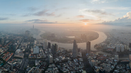 Aerial drone skyline video of Saigon cityscape at sunrise in District 1, with Sai Gon river view
