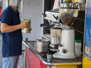 Coffee stall on Saigon street with coffee machine and coffeemaker.