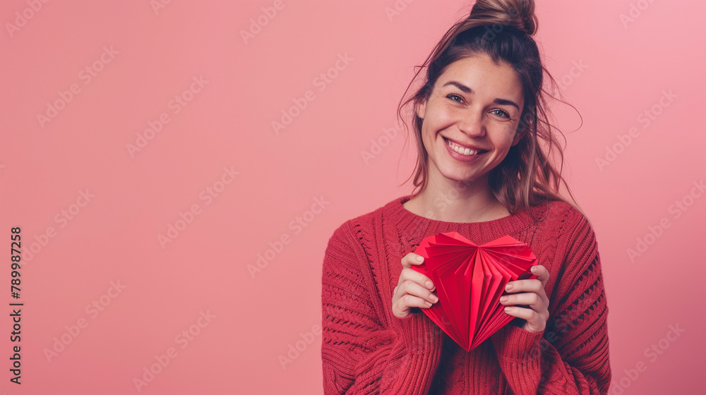 Wall mural young caucasian woman holding gift isolated on red background smiling cheerful showing a pointing with fingers and mouth.