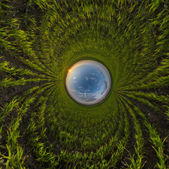 blue hole sphere little planet inside sand or dry grass round frame background