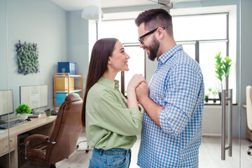 Photo of two happy business people partners feel strong love each other team building in workstation