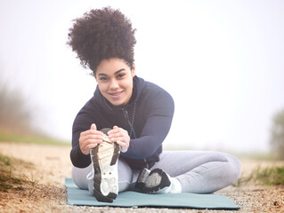 Girl, runner and stretching in morning fog on ground for health, fitness and wellness in portrait....