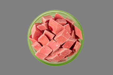 pink pieces of Uzbek dairy strawberry halva in a green bowl isolated on a gray background top view - 789991895
