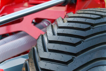 Big black truck tire close-up. Exhibition of new large-sized equipment. Cars for cargo...