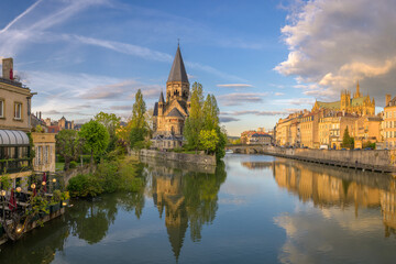 Cityscape of Metz with the river Moselle and the so called Temple Neuf Church at sunset - France