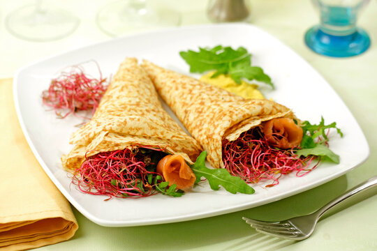 Crepes with sprouts and salmon.