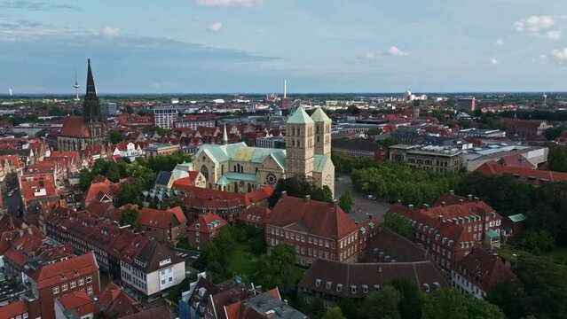 An aerial drone shot of St. Paulus Dom, also known as M&uuml;nster Cathedral, on Domplatz in M&uuml;nster on a sunny day. It is a central and culturally significant area of central M&uuml;nster, Germany. 