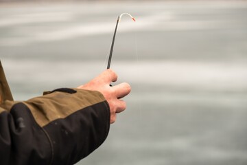 a person is holding a fishing rod in their hand