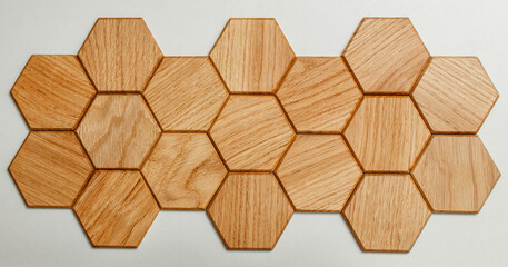 Wooden honeycomb made of maple. Hexagon in interior design. Isolated on white background