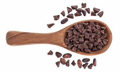 Obraz premium Cacao photo of chocolate Dark brown granules on wooden spoon isolated white background.