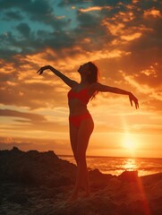 A woman in a swimsuit by the seashore or ocean against the backdrop of the sunset. Leisure and relaxation.