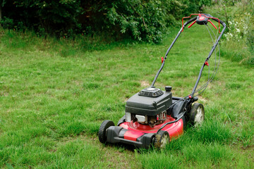 Lawn mover on green grass background. Machine for cutting lawns. Garden care. Electric equipment....