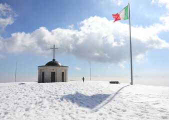 Pieve, TV, Italy - March 13, 2024: Military Memorial of Monte Grappa is an ossuary and italian flag
