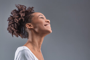 Black Woman's head back, laughing in pure joy
