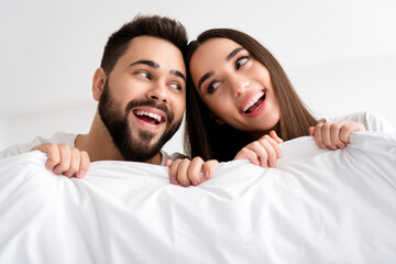 Photo of positive cheerful couple people enjoy sleep hold blanket in room house