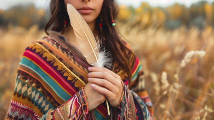 Woman in Colorful Poncho Holding Beige Feather. Female Embracing Natural Spiritual Journey. Shamanic Ritual on the Field.