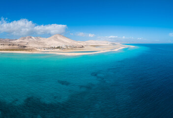 Stunning mid level aspect aerial panoramic view of the beautiful tropical looking beach, lagoon and sand dunes at Sotavento Risco del Paso beach near Costa Calma on Fuerteventura Canary Islands Spain