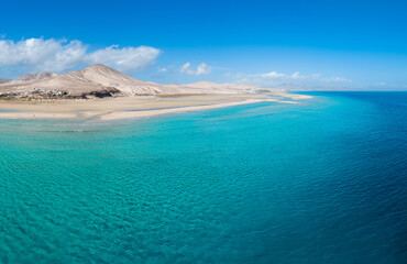 Stunning mid level aspect aerial panoramic view of the beautiful tropical looking beach, lagoon and sand dunes at Sotavento Risco del Paso beach near Costa Calma on Fuerteventura Canary Islands Spain