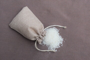 White Sugar, Sugar in bag sack with Fresh green sugar cane cut on wooden background, top view with copy space for your text message or promotional content.
