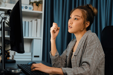 Businesswoman working on computer with stretching arm up and down manner with body health ache of...