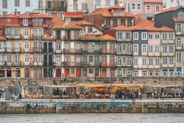 Porto, Portugal Skyline, the old town of Porto from across the Douro River. Colorful houses of Porto Ribeira, traditional facades, old multicolored houses with red tiles during a foggy day, Portugal.