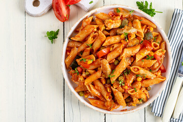 Classic italian pasta penne arrabbiata with vegetables on white wooden table. Penne pasta with sauce arrabbiata. Top view, overhead - 790032865