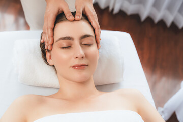 Caucasian woman enjoying relaxing anti-stress head massage and pampering facial beauty skin...
