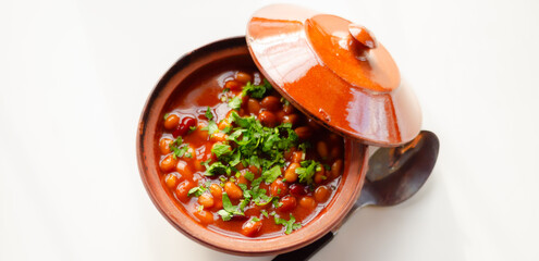 A hearty serving of baked beans in a ceramic dish, a healthy and nutritious meal