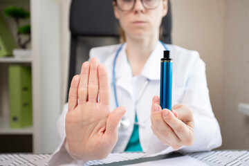 refuse vape smoking, stop electronic cigarette, doctor shows a sign of rejection of disposable ecigarette with her hand - obrazy, fototapety, plakaty