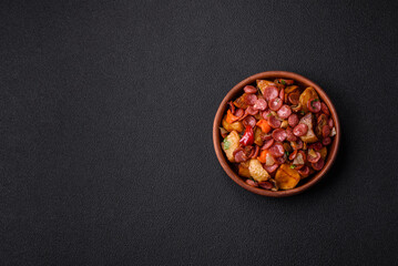 Grilled potatoes cut into slices with hunting sausages with garlic, onion