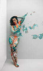 sexy nude woman in turquoise, orange and green color painted decorative. Creative expressive abstract bodypainting art