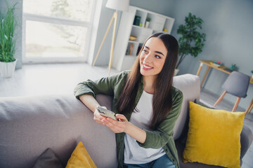 Photo of pretty young woman use phone brainstorm wear shirt modern interior apartment indoors