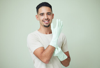 Man, cleaner and portrait with gloves in studio for housework, spring cleaning and housekeeping....