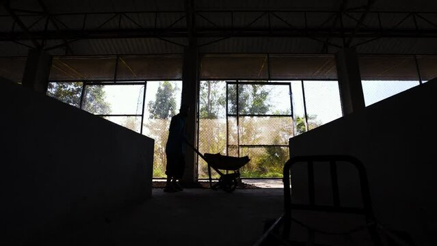 Raising earthworms in a cement pond.