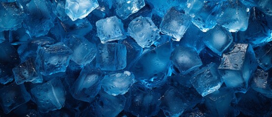 Closeup of blue ice cubes with water droplets on black surface, refreshing and cool concept for summer drinks and cocktails