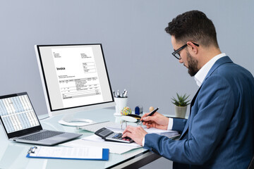 Fototapeta na wymiar Accountant Making Invoice On Computer