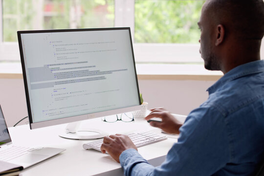 Computer Programmer Writing Program Code On Computer