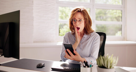 Worried Woman Looking At Smartphone And Sitting