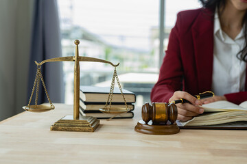 Female lawyer working in office or court Check the contract of a successful female client working with a statue of Themis, the goddess of justice. online legal advice