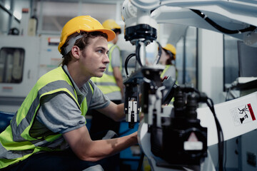 Robotic engineer examining robot arm machine for repairing service. Modern technology technician...
