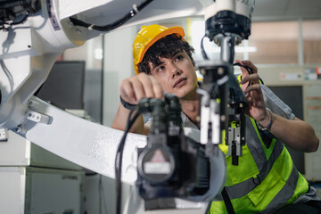 Robotic engineer examining robot arm machine for repairing service. Modern technology technician...