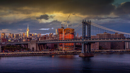 Manhattan Bridge over East River at sunset in New York City, USA. Beautiful skyline with...