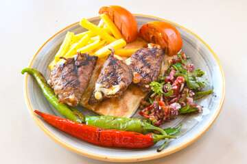 Famous Urfa meat liver, ciger wrapped by lavash with roasted chili pepper, onion and sauce in Sanliurfa, Turkey. Kuzu et ciger sis. Izgara dana bonfile, cop sis, kuzu pirzola. Karisik kebap, beyti keb