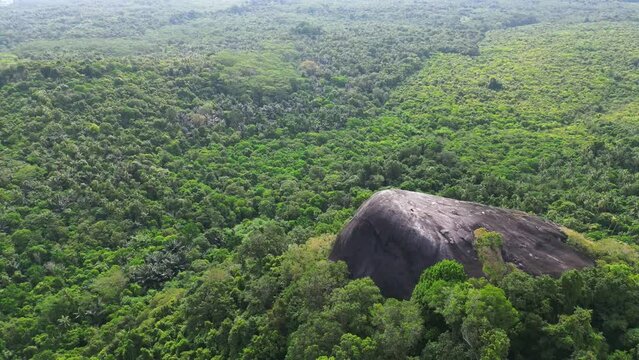 Belitung island drone aerial landscape Batu Beginda, a famous massive boulder overlooking the jungle, beach and ocean in Belitung, Indonesia